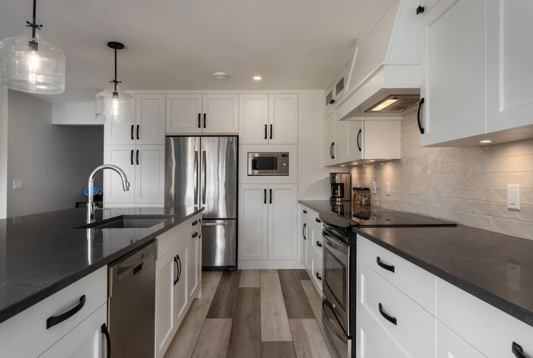 Kitchen with island and new cabinets by Amend Developments